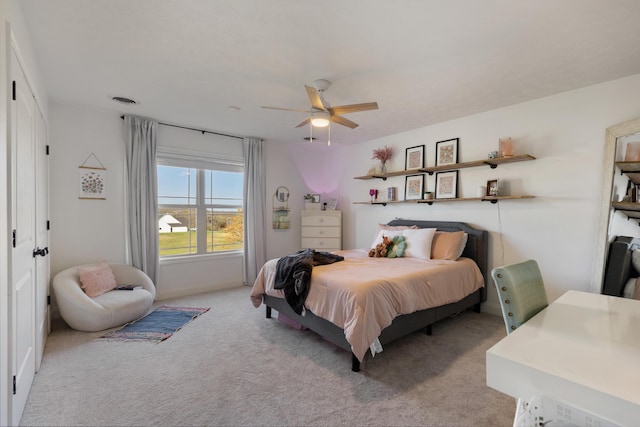 bedroom featuring light colored carpet and visible vents