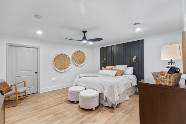 bedroom featuring a ceiling fan, ornamental molding, baseboards, and light wood finished floors