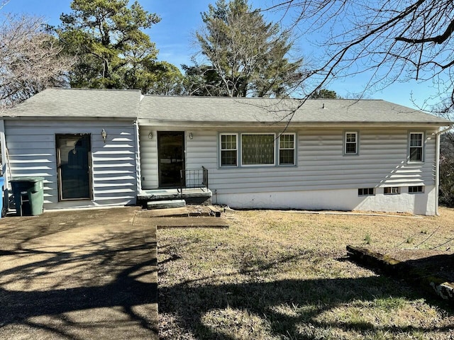 back of property featuring a lawn