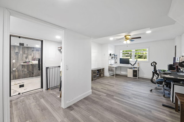 office featuring baseboards, a ceiling fan, wood finished floors, and recessed lighting