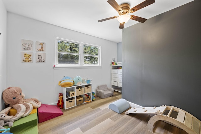 rec room with wood finished floors and a ceiling fan