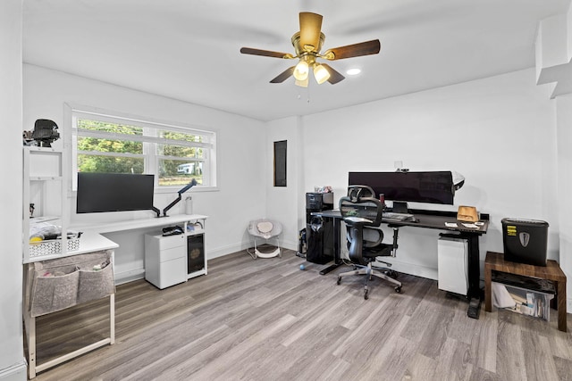 office with baseboards, a ceiling fan, and wood finished floors