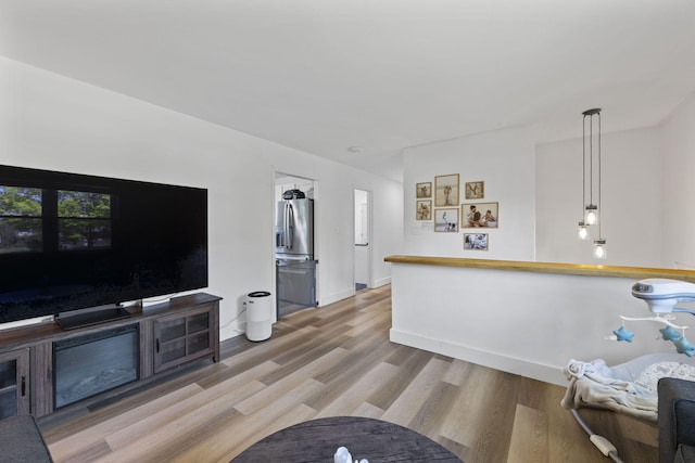 living room featuring wood finished floors and baseboards