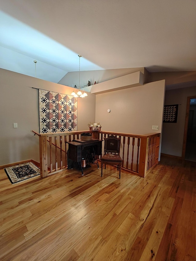156 Pine View Ln, Copperhill, TN 37317 - living area with lofted ceiling, wood finished floors, a chandelier, and an upstairs landing