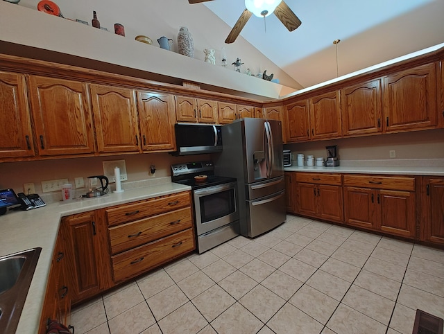 156 Pine View Ln, Copperhill, TN 37317 - kitchen featuring appliances with stainless steel finishes, vaulted ceiling, light tile patterned floors, light countertops, and brown cabinetry