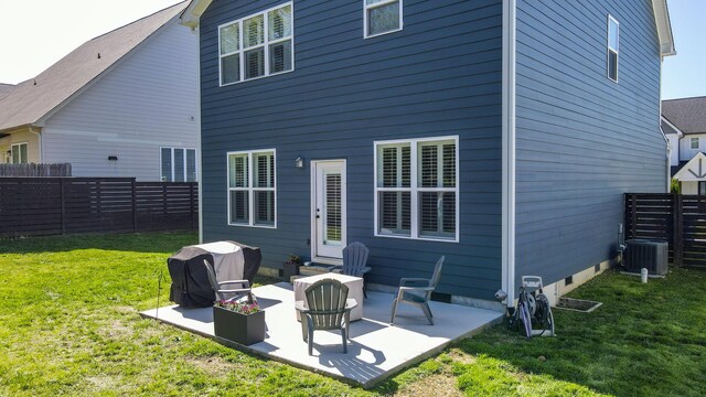 rear view of house featuring a patio area, central AC unit, a yard, and fence