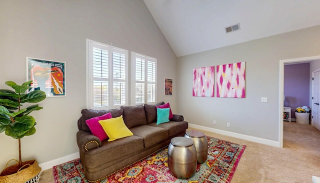 living area with high vaulted ceiling, carpet flooring, visible vents, and baseboards
