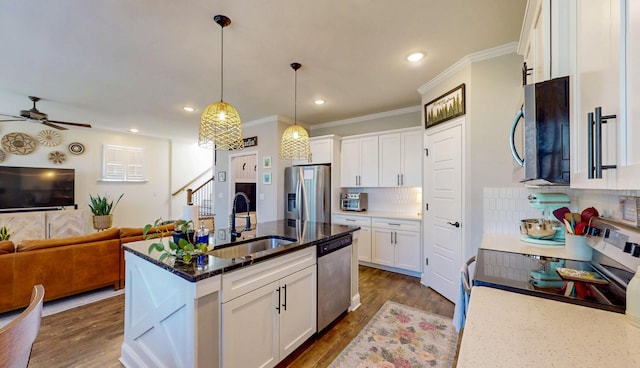 kitchen with a sink, ceiling fan, appliances with stainless steel finishes, dark wood-style floors, and white cabinetry