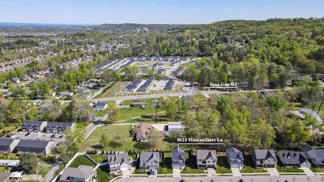 birds eye view of property with a view of trees and a residential view
