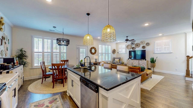 kitchen with baseboards, dishwasher, a sink, dark wood-style flooring, and ceiling fan