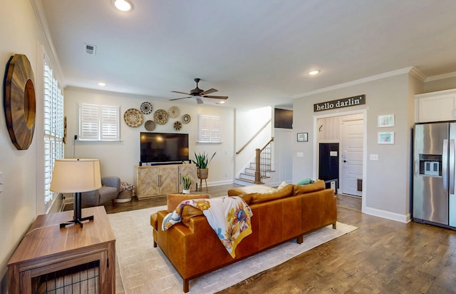 living area with dark wood finished floors, a ceiling fan, visible vents, recessed lighting, and stairs