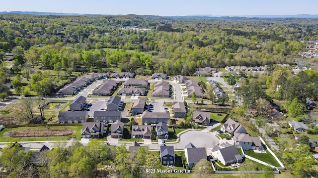 bird's eye view with a wooded view and a residential view