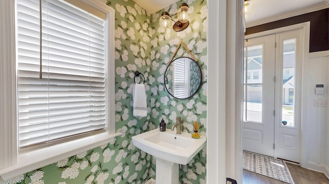 bathroom featuring wallpapered walls and wood finished floors