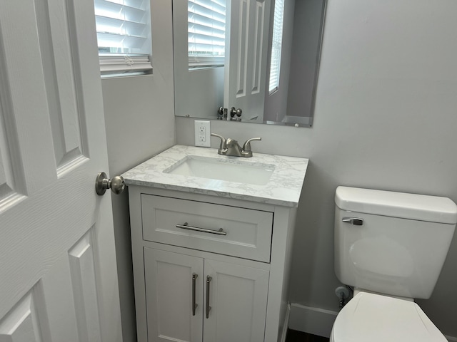 bathroom featuring toilet and vanity