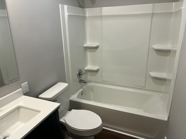 full bathroom with toilet, vanity, and shower / washtub combination