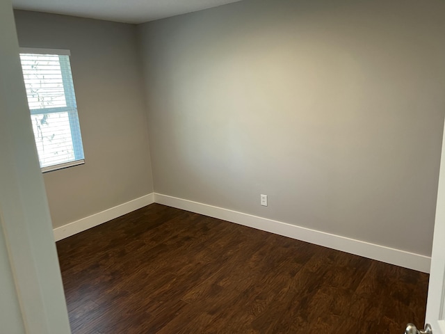 spare room with dark hardwood / wood-style floors