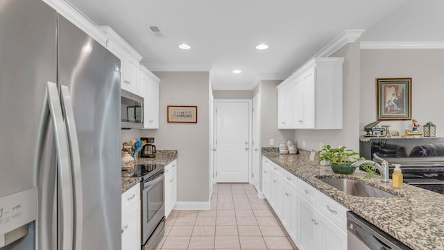 1605 Orchard Pl NE, Cleveland, TN 37323 - kitchen featuring stainless steel appliances, ornamental molding, white cabinets, light tile patterned floors, and light stone countertops