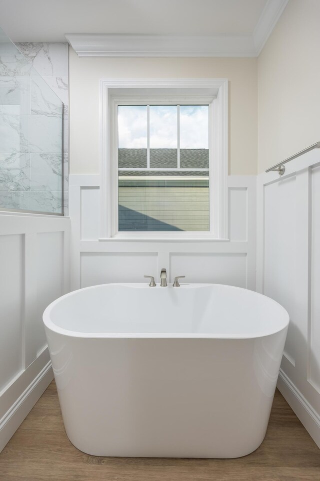5029 Solar Ln NW, Cleveland, TN 37312 - bathroom featuring a decorative wall, a wainscoted wall, a freestanding bath, and wood finished floors