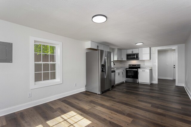 245 Graham St, Dayton, TN 37321 - kitchen with baseboards, stainless steel appliances, electric panel, and light countertops