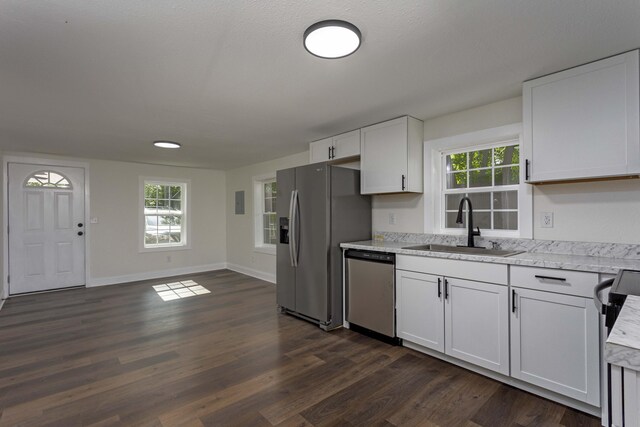 245 Graham St, Dayton, TN 37321 - kitchen featuring light stone countertops, appliances with stainless steel finishes, a sink, white cabinetry, and dark wood-type flooring