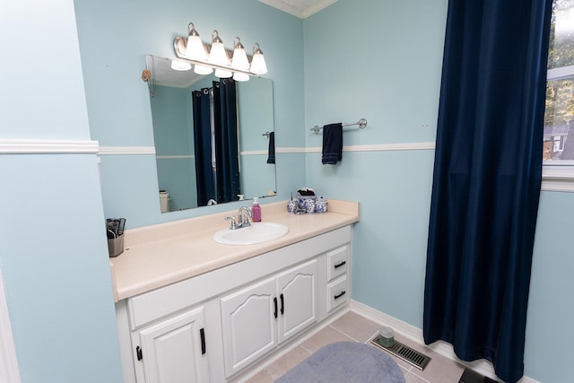 bathroom featuring crown molding, tile patterned flooring, and vanity