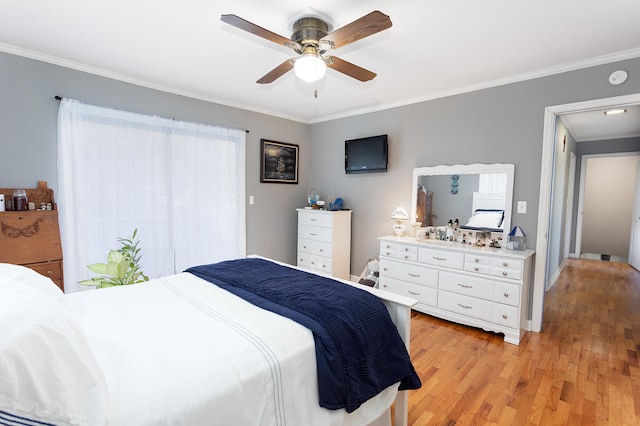 bedroom with light hardwood / wood-style flooring, ceiling fan, and ornamental molding