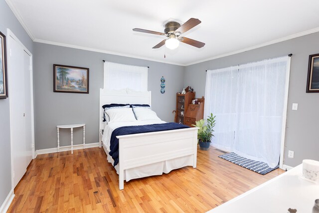 bedroom featuring hardwood / wood-style floors, ceiling fan, and ornamental molding