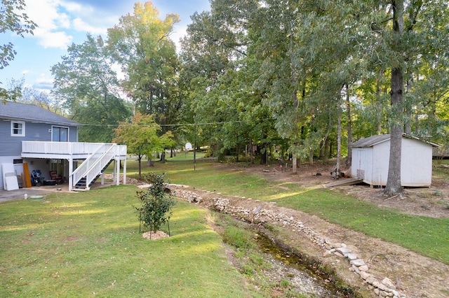 view of yard with a storage unit and a deck