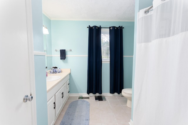 bathroom featuring vanity, tile patterned flooring, toilet, ornamental molding, and a textured ceiling