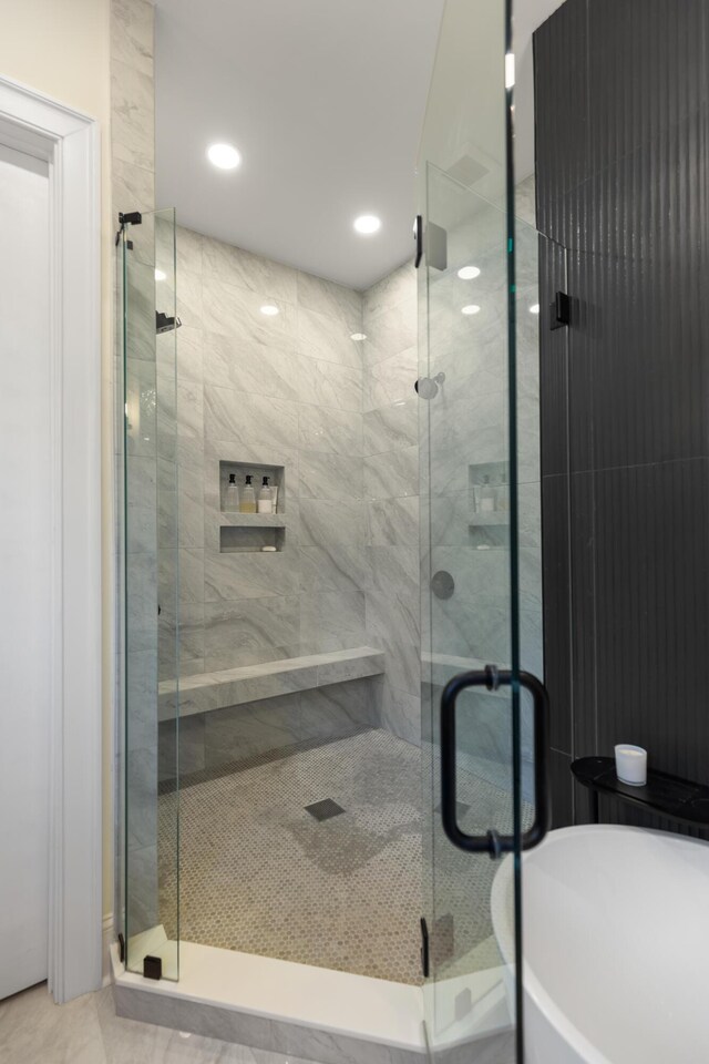 full bath with a shower stall, recessed lighting, and a freestanding bath