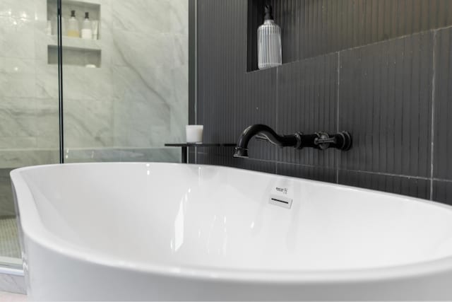 room details featuring a soaking tub and a sink