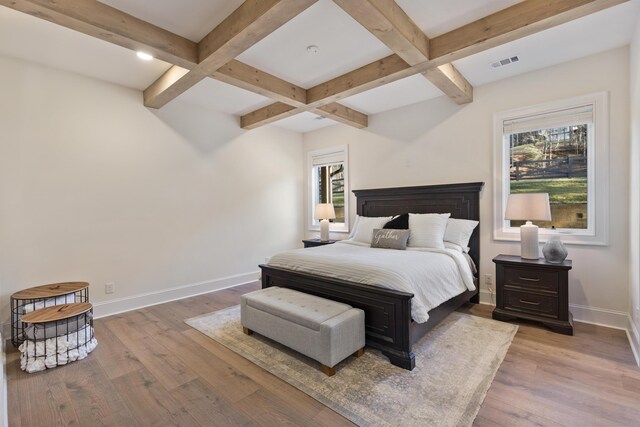 bedroom with hardwood / wood-style floors, beam ceiling, baseboards, and coffered ceiling