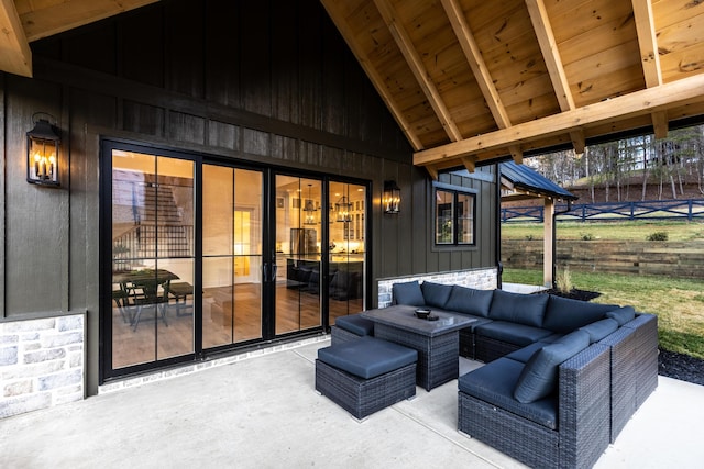 view of patio featuring an outdoor living space and fence