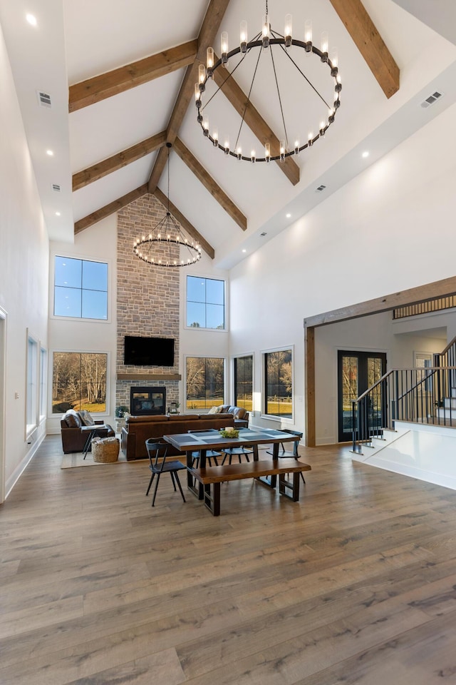 dining area with visible vents, an inviting chandelier, wood finished floors, and a fireplace