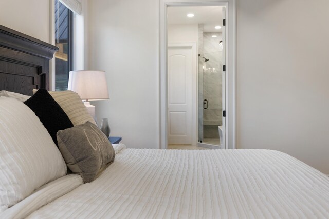 bedroom featuring connected bathroom and a fireplace