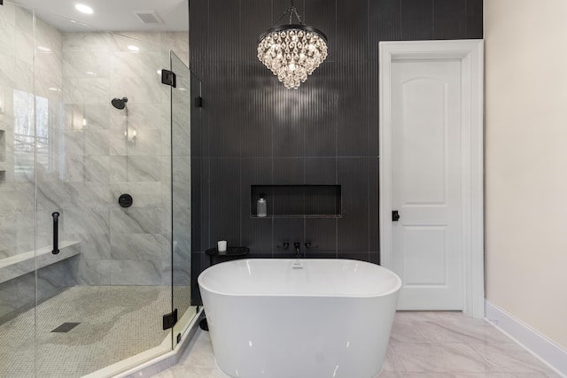 bathroom featuring visible vents, marble finish floor, a stall shower, an inviting chandelier, and a soaking tub