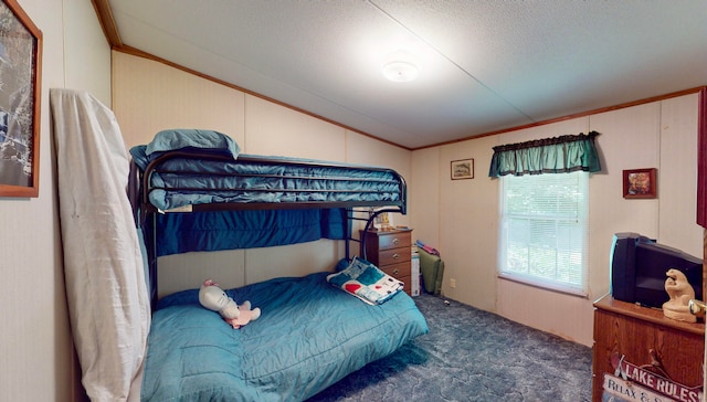 bedroom with dark colored carpet, crown molding, lofted ceiling, and a textured ceiling