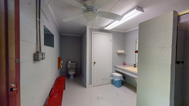 bathroom featuring ceiling fan, concrete floors, and toilet