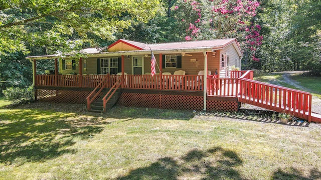 rear view of house featuring a deck and a lawn