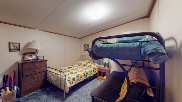 carpeted bedroom featuring a textured ceiling, crown molding, and vaulted ceiling