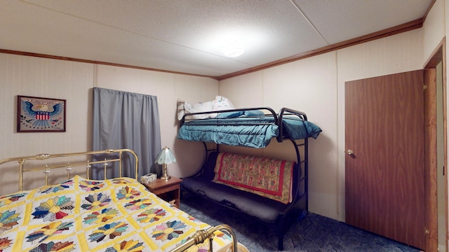 bedroom featuring crown molding and dark colored carpet