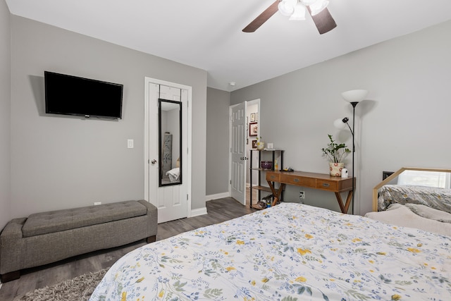 bedroom with ceiling fan, a closet, and dark wood-type flooring