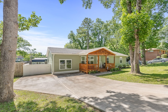 single story home with covered porch and a front yard