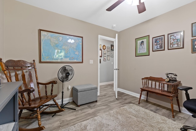 living area with light wood-type flooring and ceiling fan