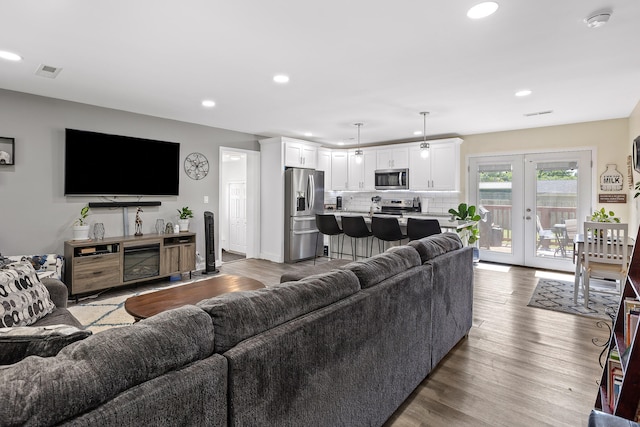 living room featuring french doors and light hardwood / wood-style flooring