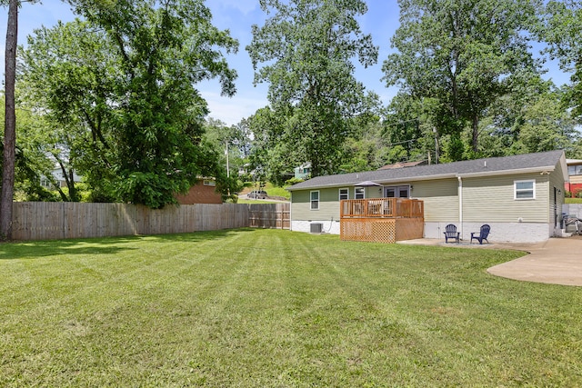 view of yard with a wooden deck, a patio area, and central AC