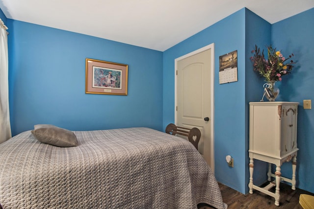 bedroom with dark hardwood / wood-style flooring