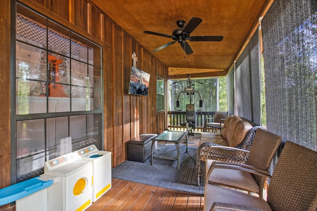 sunroom featuring washing machine and clothes dryer, ceiling fan, wooden ceiling, and vaulted ceiling