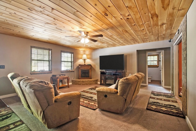 living room with carpet floors, a wood stove, plenty of natural light, and wooden ceiling