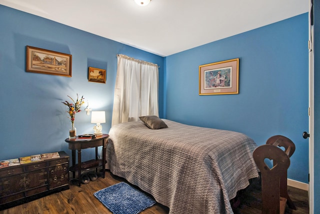 bedroom featuring dark hardwood / wood-style flooring